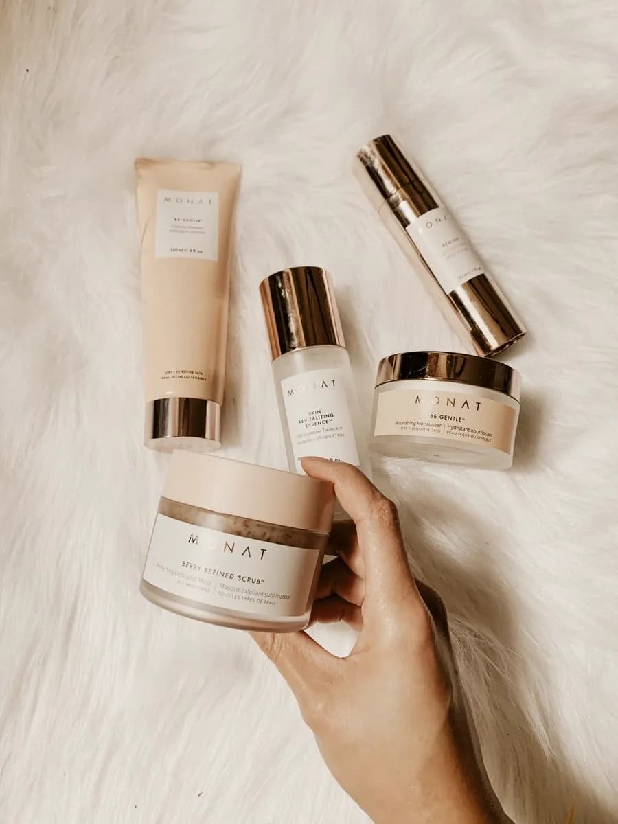 A short shelf of skincare in warm light
